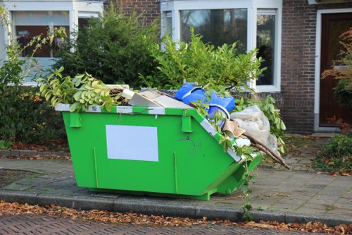 Crew loading garden waste into a van for disposal